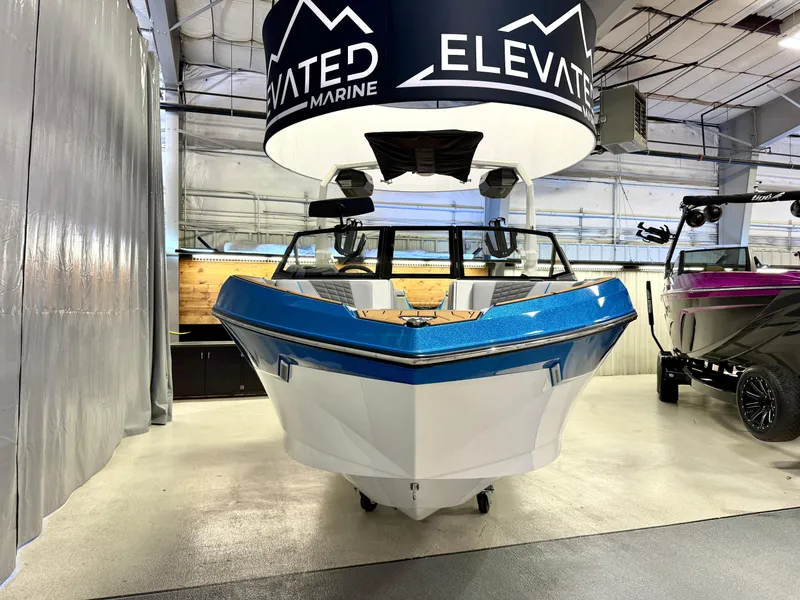 Slide: The Image of 2025 Nautique Super Air Nautique S23 boat displayed indoors at Elevated Marine showroom. - 8