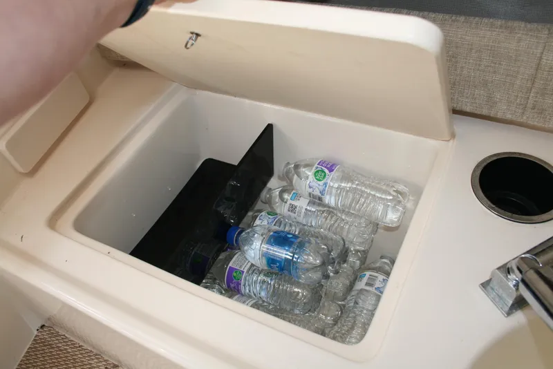 Slide: The Image of Built-in cooler with bottled water on a 2021 Grady-White 232 Gulfstream boat. - 10