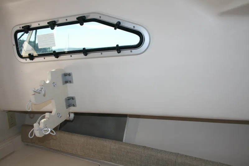 Slide: The Image of Interior of 2021 Grady-White 232 Gulfstream boat, featuring a window and mounted equipment. - 11