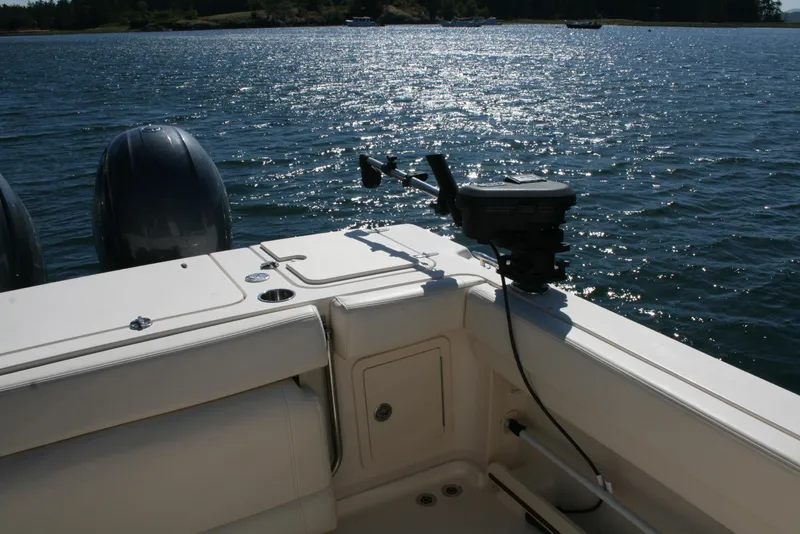 Slide: The Image of Grady-White 232 Gulfstream 2021 boat on water, featuring dual engines and fishing equipment. - 15