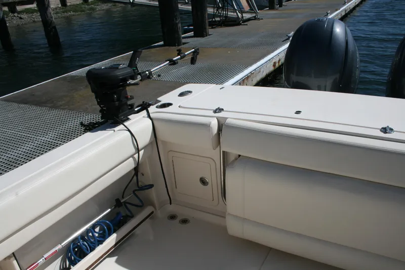 Slide: The Image of 2021 Grady-White 232 Gulfstream boat interior with docked engines and fishing equipment. - 16