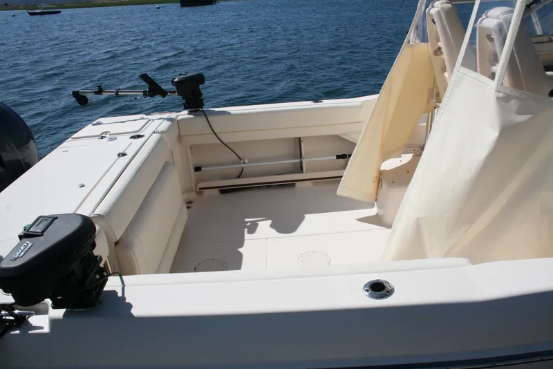 Slide: The Image of 2021 Grady-White 232 Gulfstream boat interior with fishing rod holders on a sunny day. - 17