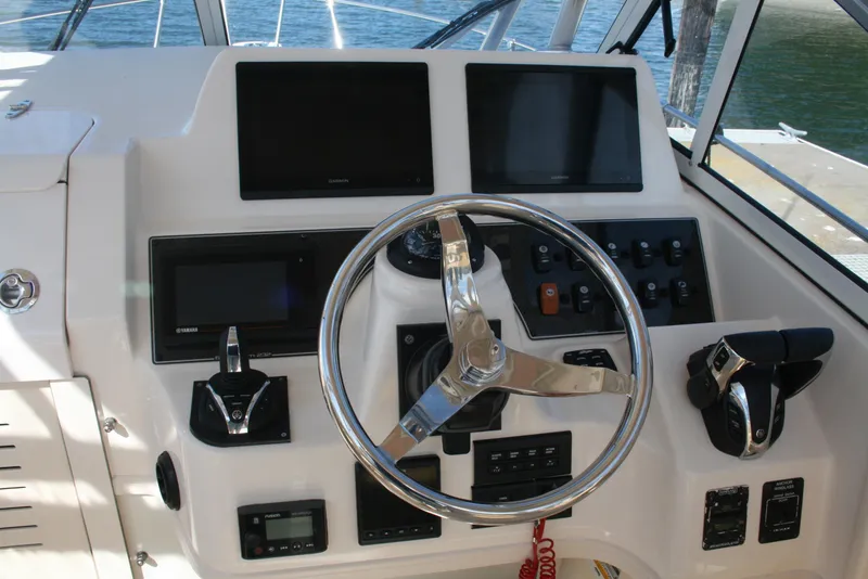 Slide: The Image of Helm of 2021 Grady-White 232 Gulfstream boat with steering wheel and control panels. - 2