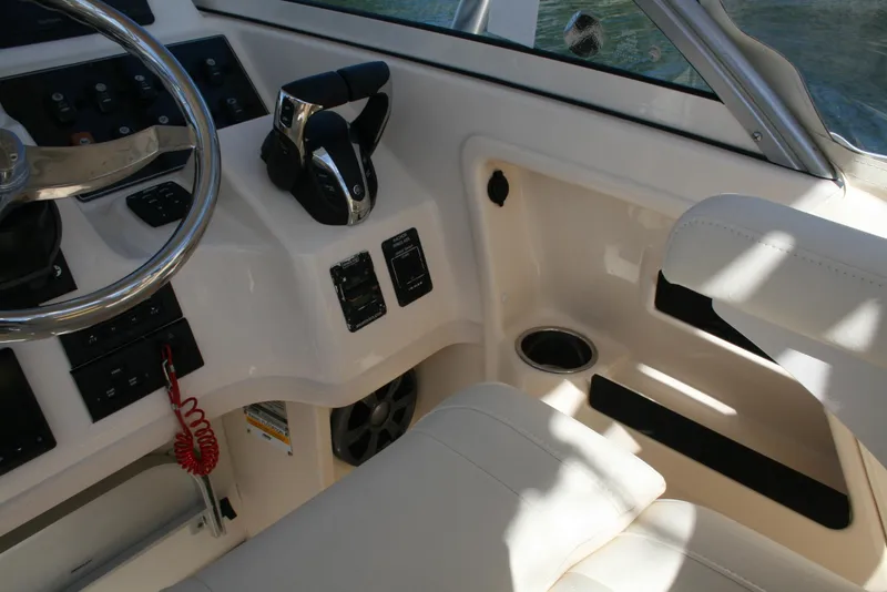 Slide: The Image of 2021 Grady-White 232 Gulfstream boat cockpit with steering wheel and controls. - 4
