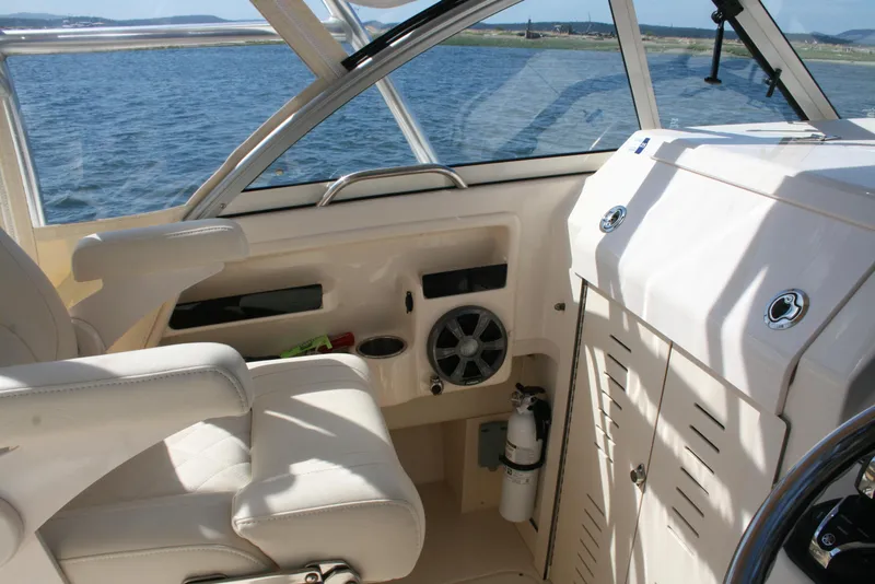 Slide: The Image of 2021 Grady-White 232 Gulfstream boat interior with helm, seat, and ocean view. - 6