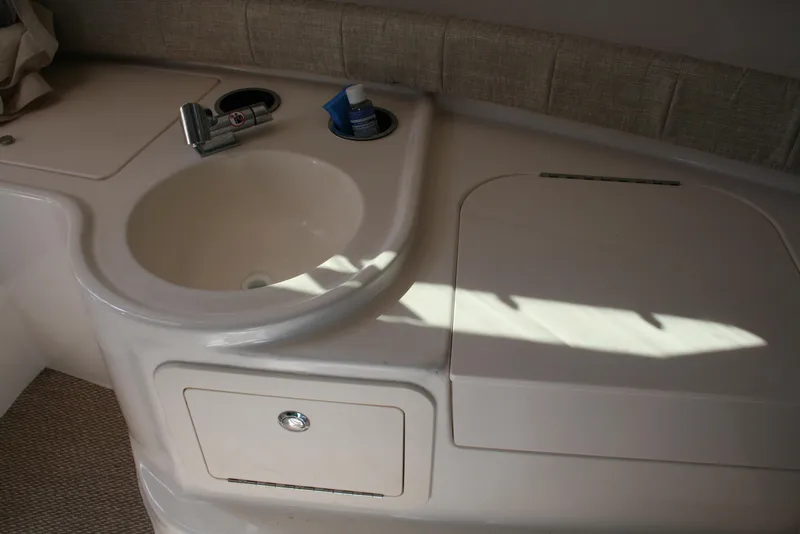 Slide: The Image of Interior sink area of 2021 Grady-White 232 Gulfstream boat, featuring faucet and storage. - 9