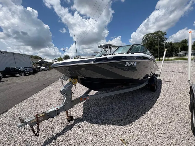 The Image of 2014 Yamaha Boats SX192 on trailer under cloudy sky. - 1
