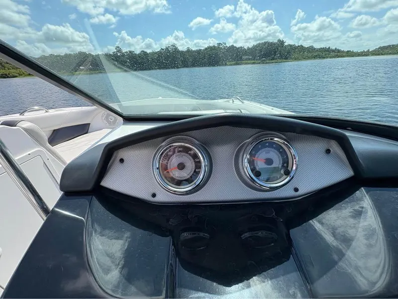 Slide: The Image of Dashboard view of a 2014 Yamaha SX192 boat on a sunny lake. - 12
