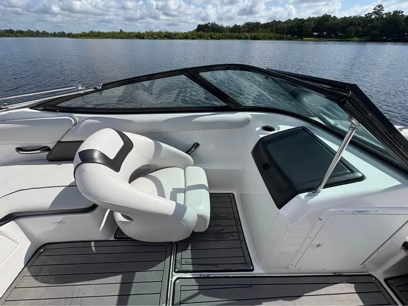 Slide: The Image of 2014 Yamaha SX192 boat interior with white seating and black accents on a calm lake. - 6