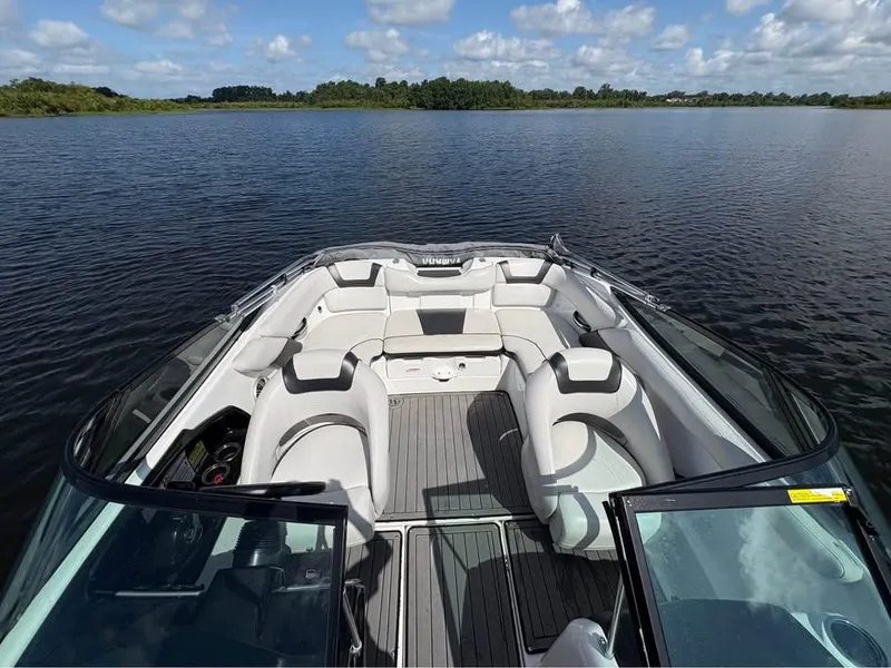 Slide: The Image of 2014 Yamaha Boats SX192 interior on calm lake with clear sky. - 8