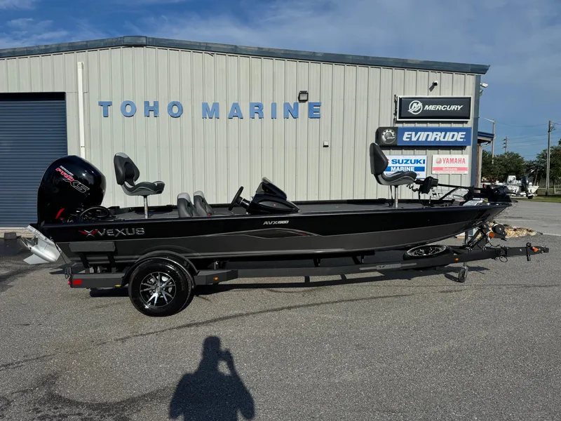 Slide: The Image of 2026 Vexus AVX1980 boat at Toho Marine dealership, featuring sleek design and modern outboard motor. - 0