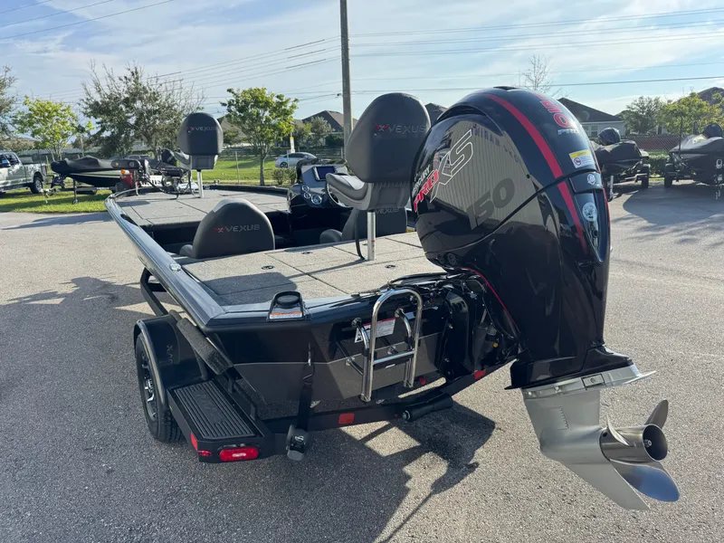 Slide: The Image of 2026 Vexus AVX1980 boat with powerful outboard motor, parked outdoors on a sunny day. - 17