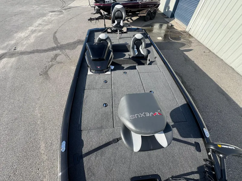 Slide: The Image of 2026 Vexus AVX1980 fishing boat with seating and storage, parked outdoors. - 8