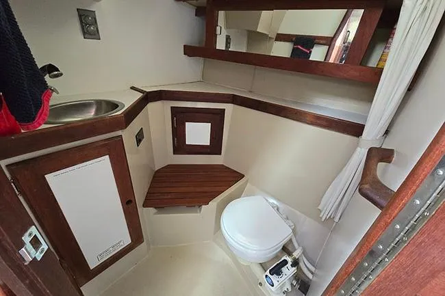 Slide: The Image of 1988 Catalina 34 mkI yacht bathroom with sink, toilet, and wooden accents. - 12