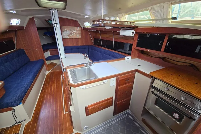 Slide: The Image of Interior of 1988 Catalina 34 mkI sailboat with kitchen and seating area. - 14