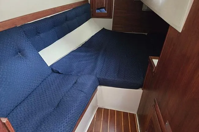 Slide: The Image of 1988 Catalina 34 mkI interior cabin with blue upholstery and wooden accents. - 15