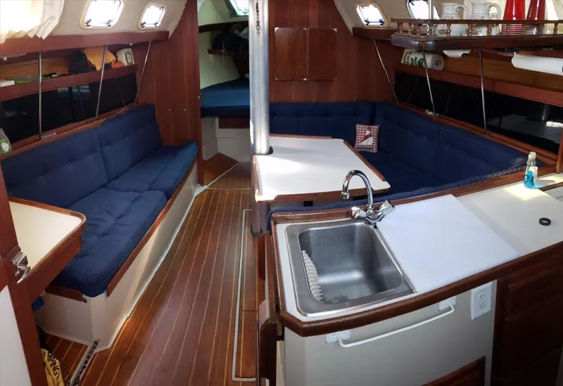 Slide: The Image of Interior of 1988 Catalina 38 MKi sailboat with blue seating and wooden finishes. - 3