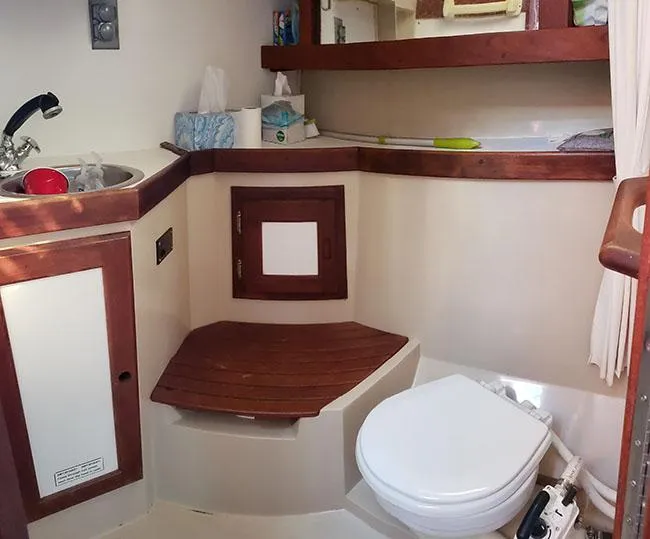Slide: The Image of 1988 Catalina 38 MKi yacht bathroom with sink, toilet, and wooden accents. - 6