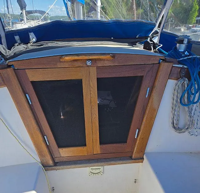 Slide: The Image of Wooden hatch doors on a 1988 Catalina 38 MKi sailboat cockpit. - 7