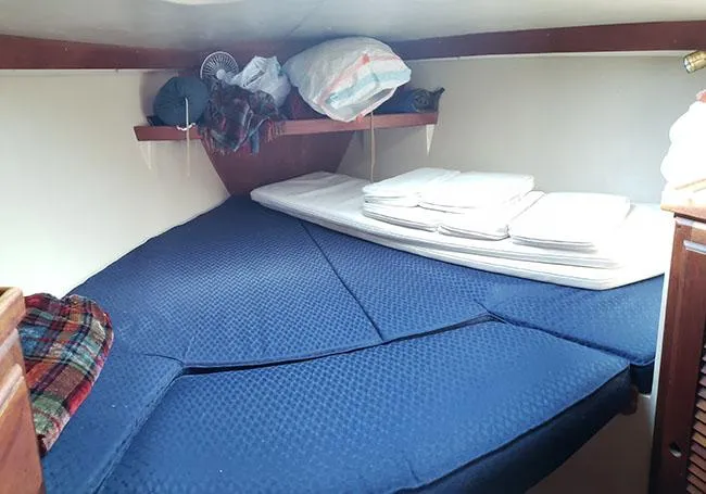 Slide: The Image of Cozy cabin interior of 1988 Catalina 38 MKi sailboat with blue bedding and storage shelves. - 9