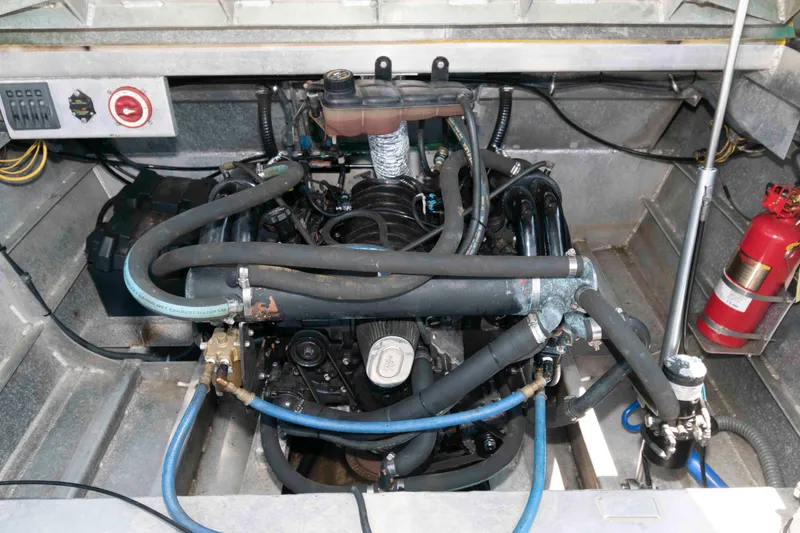 Slide: The Image of Engine compartment of a 2014 Custom Smokey Mountain Jet Boat with visible hoses and fire extinguisher. - 10