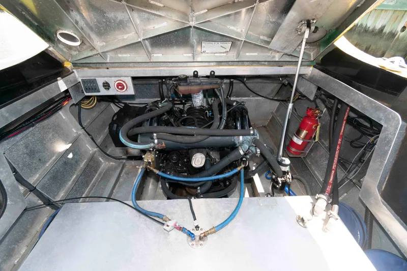 Slide: The Image of Engine compartment of a 2014 Custom Smokey Mountain Jet Boat with visible fire extinguisher. - 11