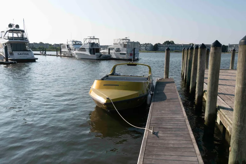 Slide: The Image of Yellow Smokey Mountain Jet Boat docked at marina, surrounded by other boats. - 3