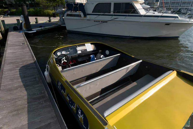 Slide: The Image of Yellow Smokey Mountain Jet Boat docked beside a larger vessel, 2014 model. - 5