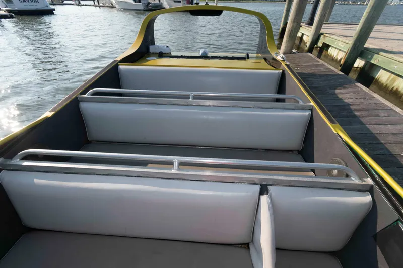 Slide: The Image of 2014 Custom Smokey Mountain Jet Boat docked, featuring sleek seating and open design. - 7