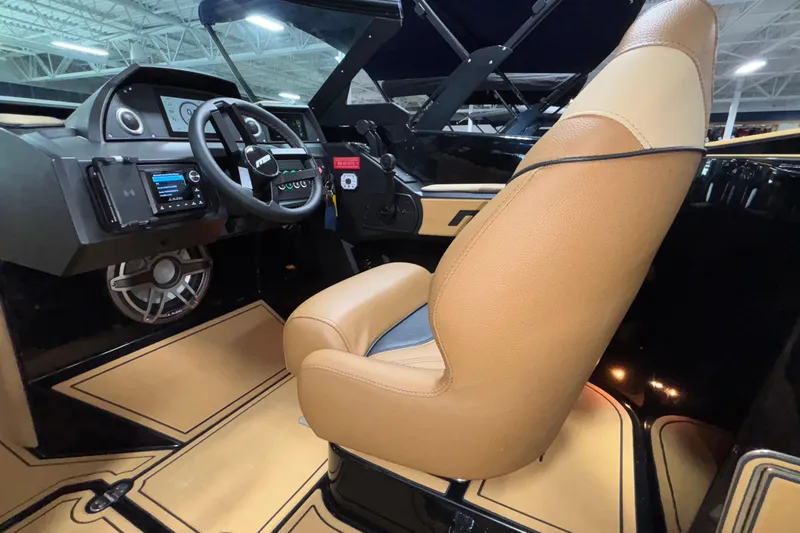 Slide: The Image of Interior of 2025 MB B52 25 Alpha boat with tan leather seating and modern dashboard. - 18