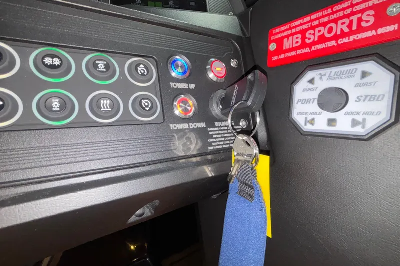 Slide: The Image of Control panel of 2025 MB B52 25 Alpha boat with ignition keys and switches. - 22