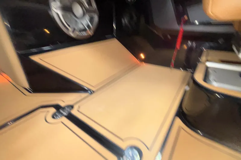 Slide: The Image of Interior of 2025 MB B52 25 Alpha boat with tan seating and speaker system. - 26