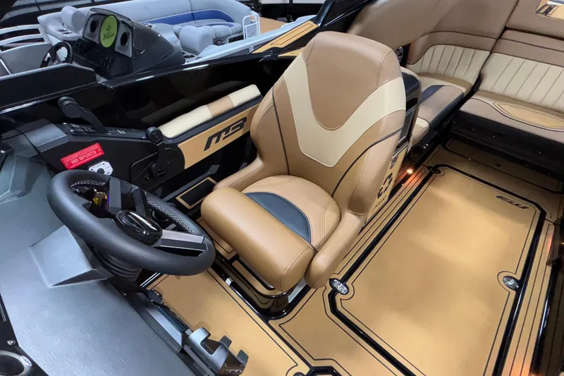 Slide: The Image of 2025 MB B52 25 Alpha boat interior with tan leather seating and modern dashboard. - 27