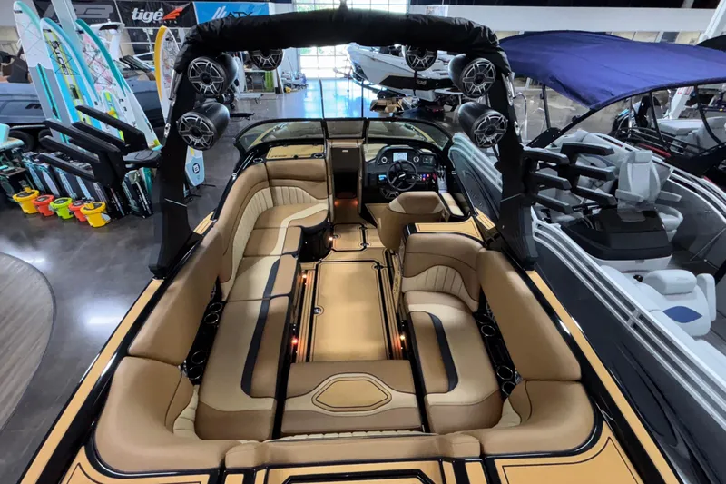Slide: The Image of 2025 MB B52 25 Alpha boat interior with tan seating and advanced audio system. - 47