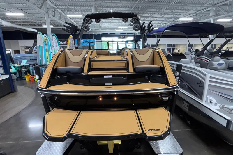 Slide: The Image of 2025 MB B52 25 Alpha boat displayed in showroom, featuring sleek design and tan upholstery. - 48