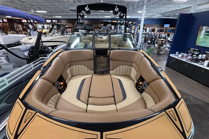 Slide: The Image of 2025 MB B52 25 Alpha boat interior with luxurious tan seating in showroom. - 56