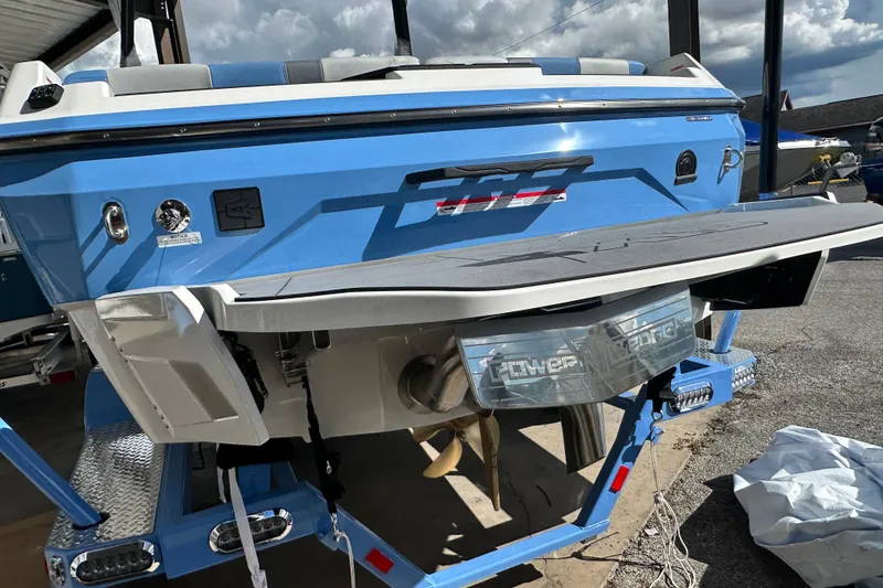 Slide: The Image of 2026 Axis A225 boat rear view, blue exterior, with swim platform and Power Wedge feature. - 15
