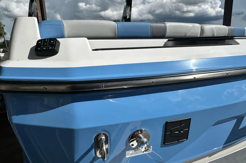 Slide: The Image of 2026 Axis A225 boat with blue and white exterior, featuring a control panel and seating. - 16