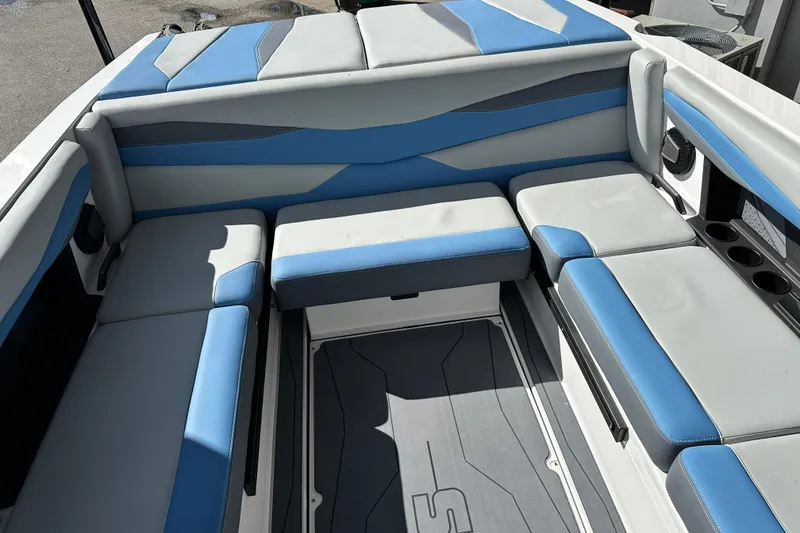 Slide: The Image of 2026 Axis A225 boat interior with blue and gray seating, cup holders, and modern design. - 4