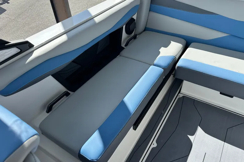 Slide: The Image of 2026 Axis A225 boat interior with blue and gray seating, modern design. - 6
