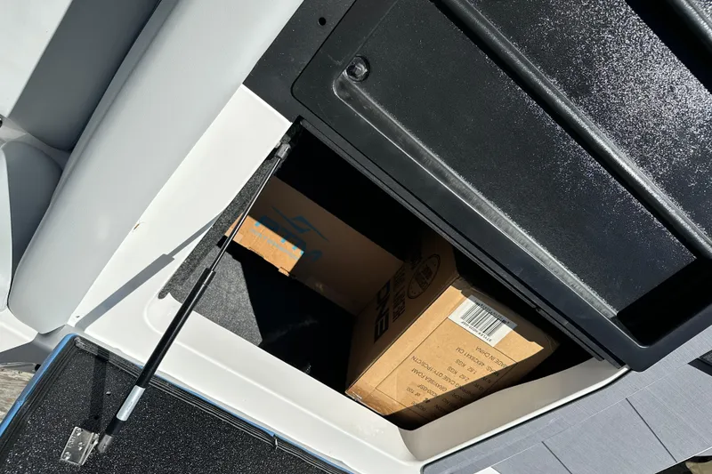 Slide: The Image of Storage compartment in a 2026 Axis A225 boat with cardboard boxes inside. - 7
