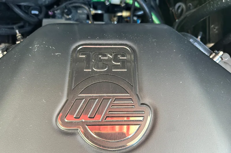 Slide: The Image of Engine cover of 2026 Axis A225 with embossed logo and design. - 9