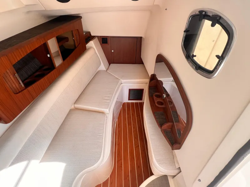 Slide: The Image of 2016 Grady-White Freedom 375 cabin interior with wood accents and comfortable seating. - 13