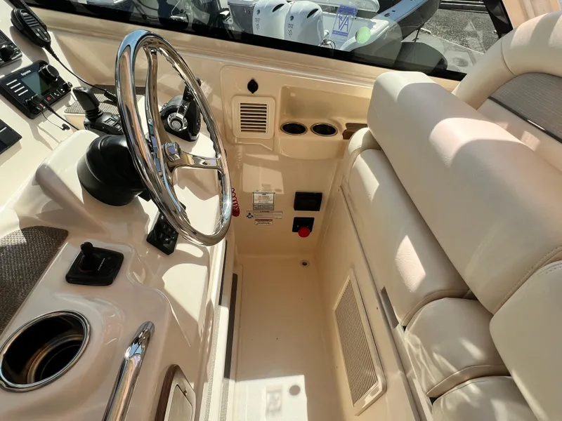 Slide: The Image of 2016 Grady-White Freedom 375 boat interior with steering wheel and control panel. - 15