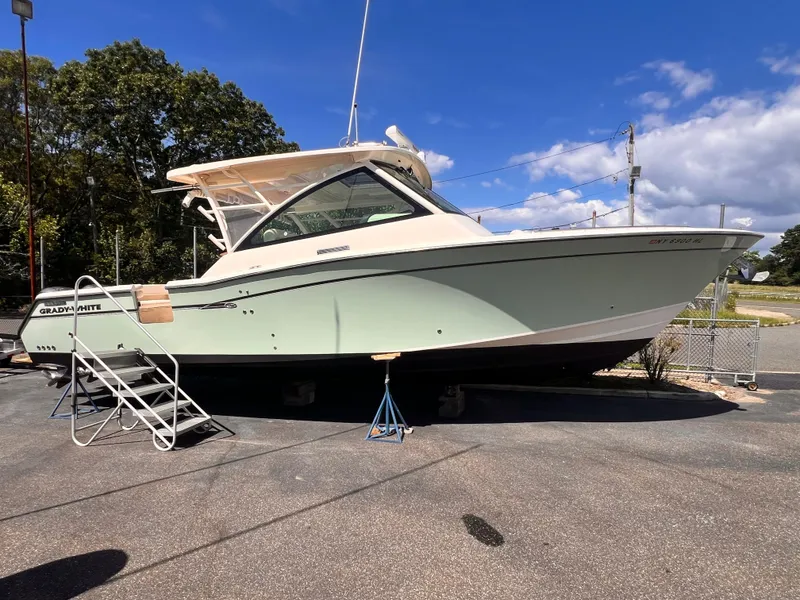 Slide: The Image of 2016 Grady-White Freedom 375 boat on display under clear blue sky. - 2