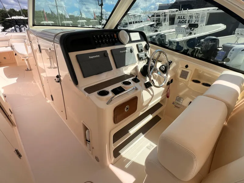 Slide: The Image of 2016 Grady-White Freedom 375 boat interior with steering wheel and control panel. - 22