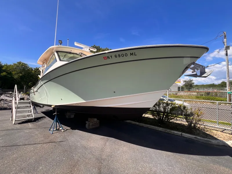 Slide: The Image of 2016 Grady-White Freedom 375 boat on dry dock under clear blue sky. - 3
