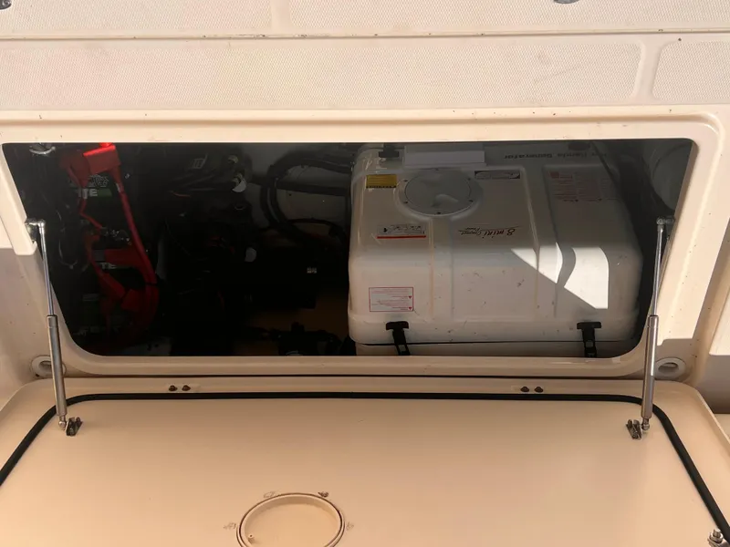 Slide: The Image of Engine compartment of a 2016 Grady-White Freedom 375 boat, showing generator and battery setup. - 5