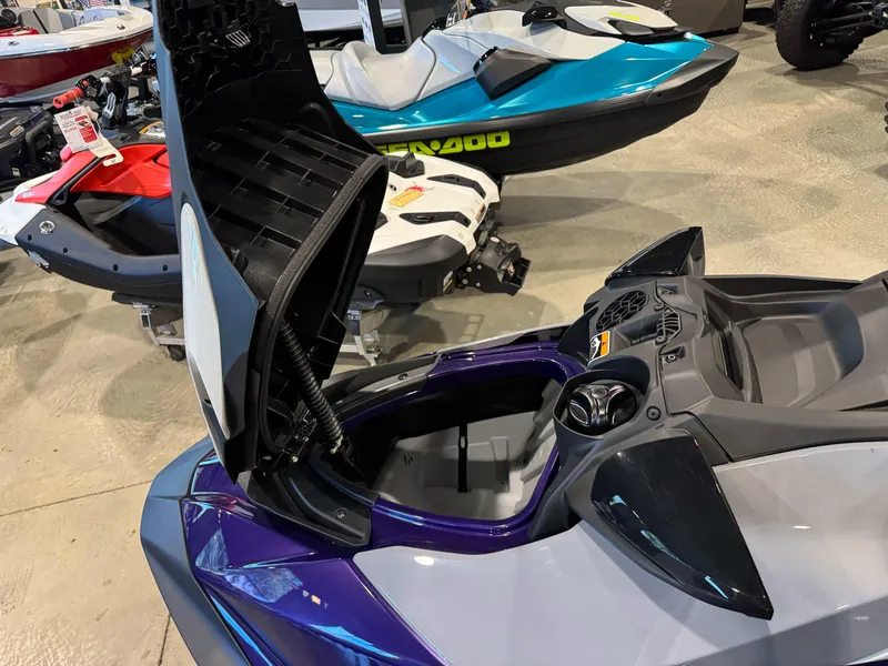 Slide: The Image of 2025 Sea-Doo GTI SE 130 with open storage compartment, displayed in showroom. - 8