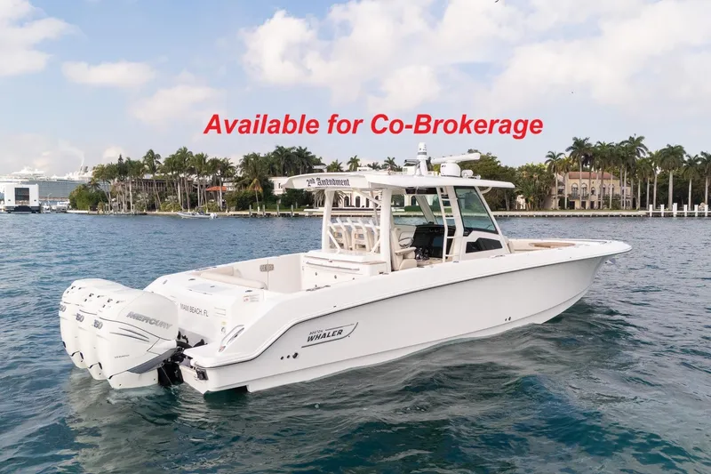 The Image of 2020 Boston Whaler 380 Outrage cruising near city skyline, available for co-brokerage. - 0